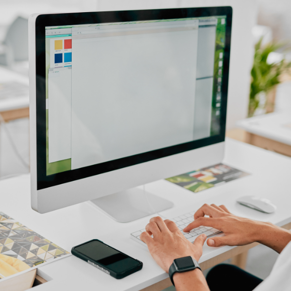 cropped image of a designer's hands working on a computer to come up with beautiful bigcommerce website designs