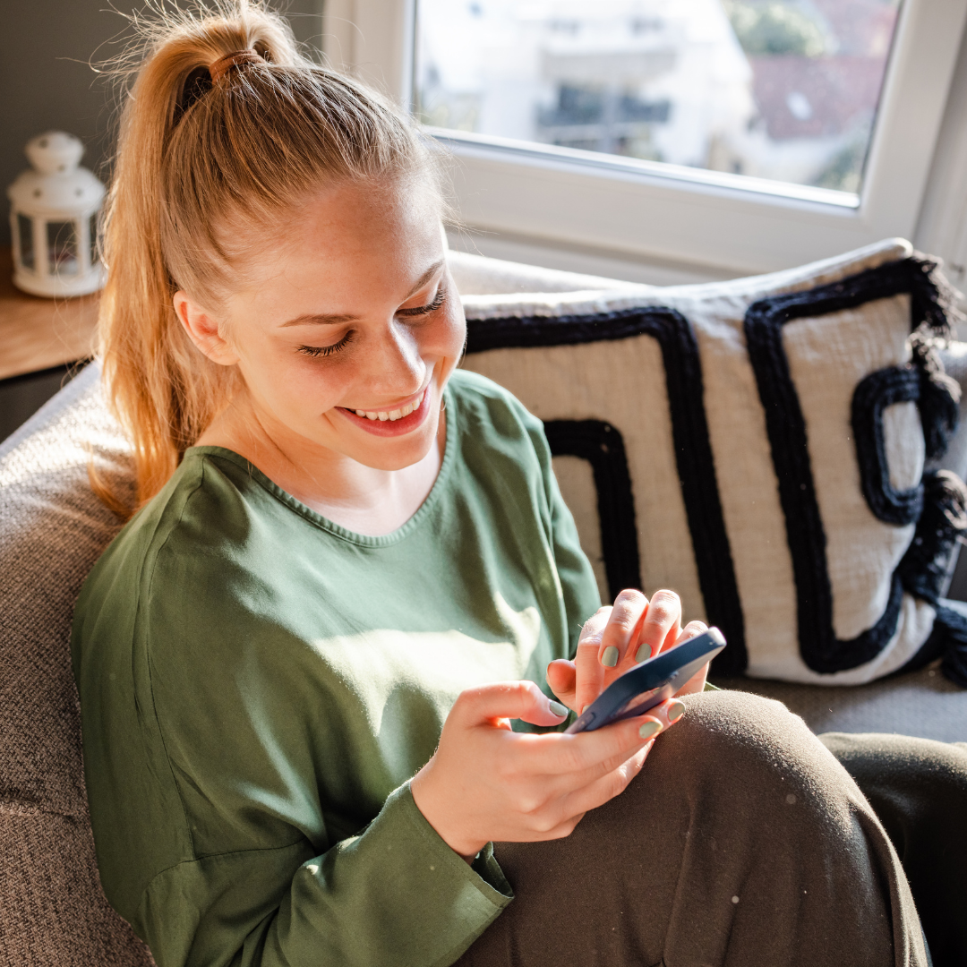 A smiling woman browsing a site with a user-friendly BigCommerce website design