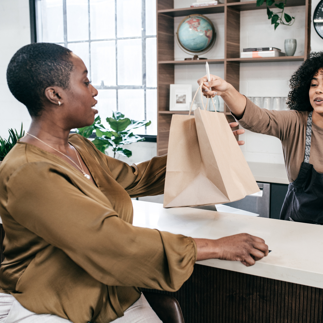 Woman picking up her order from the store. An example of BigCommerce BOPIS