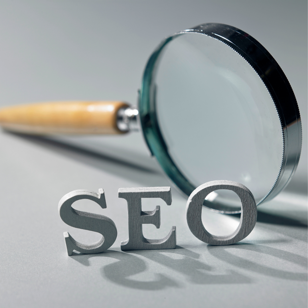 A magnifying glass with the words SEO next to it, symbolizing BigCommerce seo