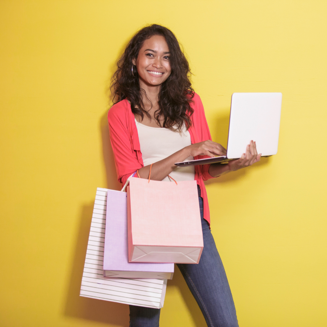 Asian woman holding shopping bags and doing her shopping from an online store with an engaging BigCommerce design.