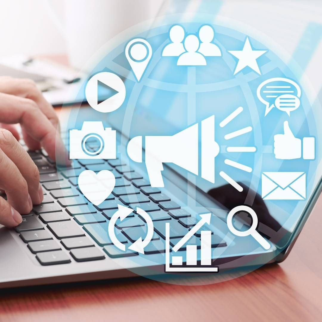 Hands typing on a laptop with marketing icons overlay: megaphone, chat, search, growth chart, and email.