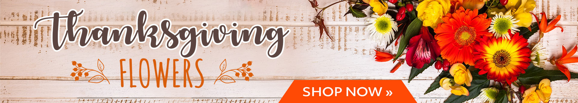 Thanksgiving flowers banner with bright orange and yellow bouquet on rustic wood and an orange Shop Now button.
