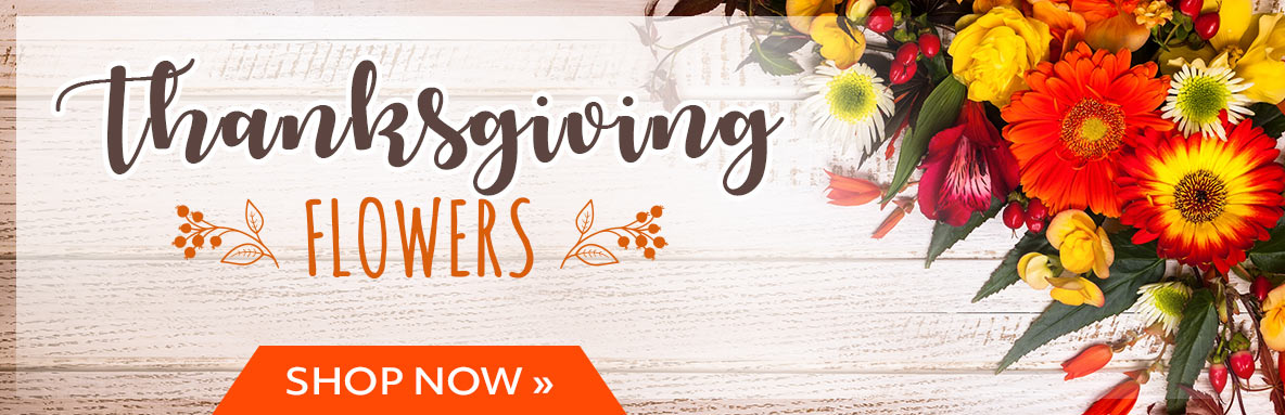 Thanksgiving flowers banner with bright orange and yellow bouquet on rustic wood and an orange Shop Now button.
